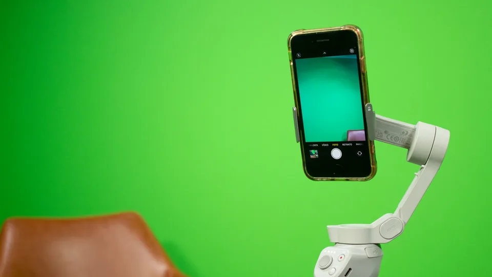 A phone on a gimbal recording against a green screen