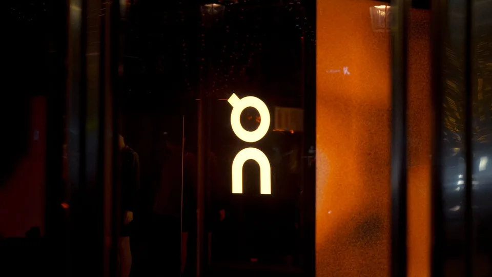A street scene with a lit storefront sign